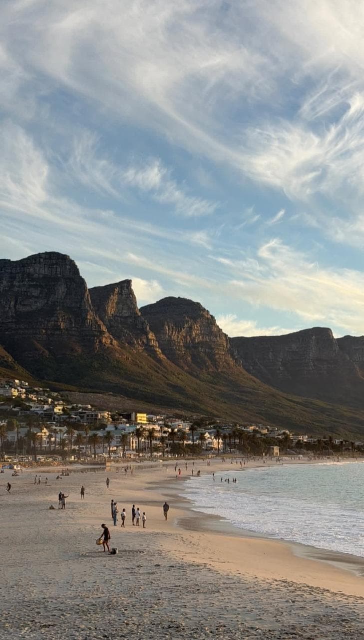 Camps Bay at dusk, mountains behind the beach